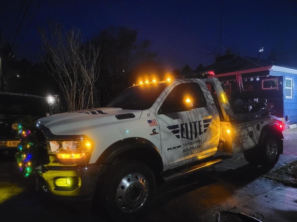 Elite Towing truck decorated with Christmas lights